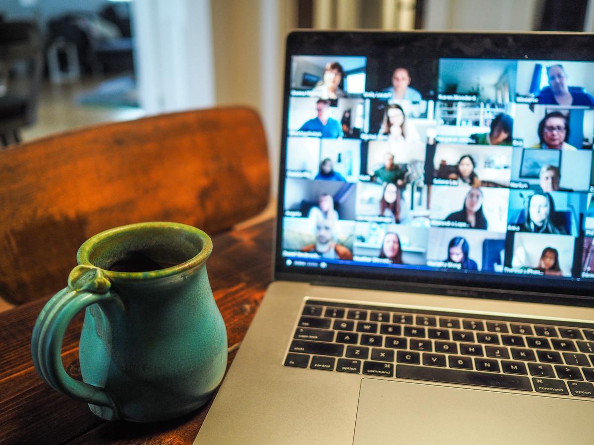 Image of a person conducting a video deposition with a laptop and microphone.